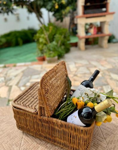 a basket with a bottle of wine and flowers at Casa Sarguito in Sagres