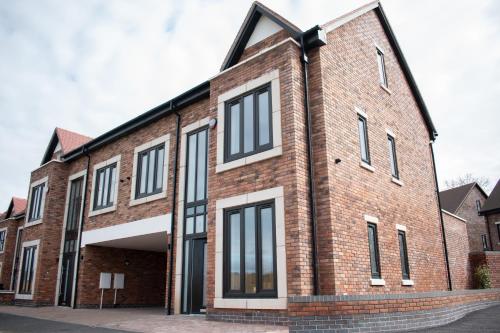 a brick building with black and white windows at Spacious 6 bedroom House - Sleeps 11, Convenient Location, Perfect for FAMILIES in Birmingham