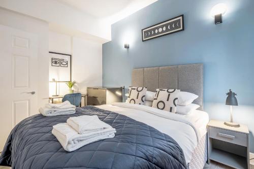 a bedroom with a large bed with towels on it at Kula London - Tower Bridge in London