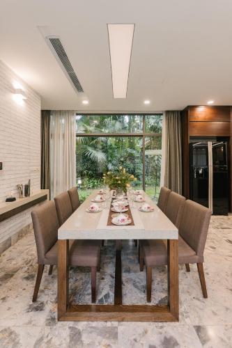 a dining room with a long table and chairs at Rosee Villa - Green Villa with private Pool in Vĩnh Phúc