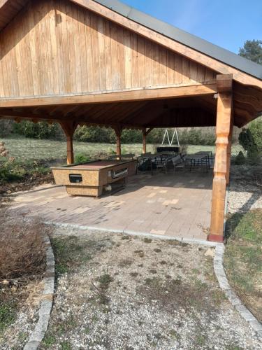 a large wooden pavilion with a picnic table under it at Domek cało roczny na Mazurach z własnym stawem nad jeziorem Ołów 