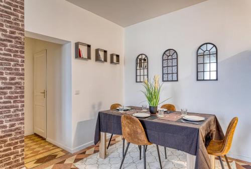 a dining room with a table and chairs at L'Escale - Airport - Paris in Goussainville