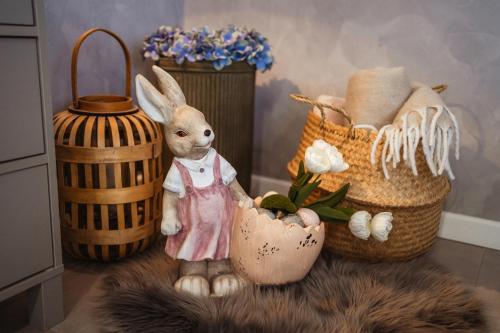 a figurine of a rabbit standing next to baskets at Apartmany pod Pustevnami in Prostřední Bečva