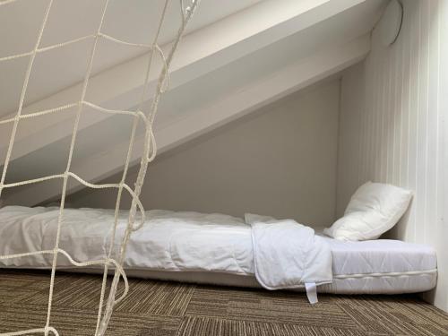 a bed in the corner of a room at Hotel Desatero in Mikulov