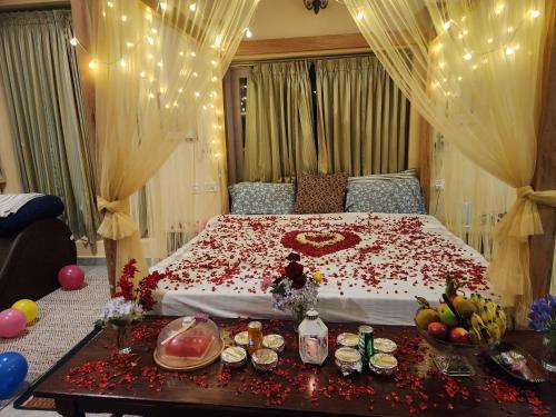 a bedroom with a large bed with flowers on it at Cloudwalks Homestay in Kodaikānāl