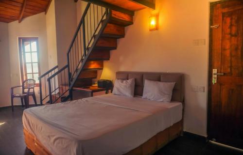 a bedroom with a bed with a staircase in it at GlenfallsRest in Nuwara Eliya