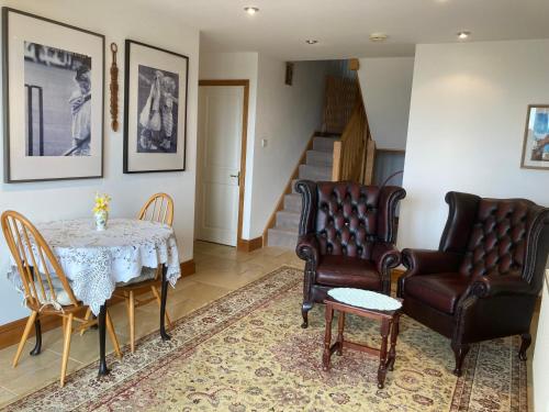 a living room with a table and two chairs at Yellowstone, The Garden Apartment in Radstock