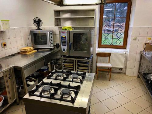 a kitchen with a stove and a microwave at Chata Polka in Horní Vltavice