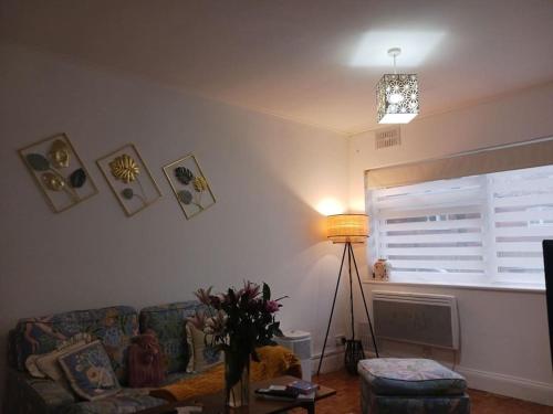 a living room with a couch and a window at Stanmore in Stanmore