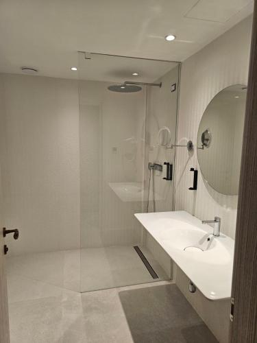 a bathroom with a sink and a shower at Abi's Hotel & SPA Vlore in Vlorë