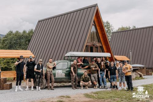 a group of people standing in front of a truck at Transylvania Apartments in Borzont