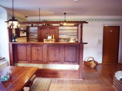 a kitchen with wooden cabinets and a wooden table at Chata Polka in Horní Vltavice