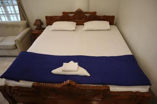 a bedroom with a bed with a hat on it at SWET APARAJITA in Bolpur