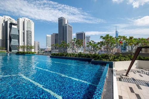 a large swimming pool with a city skyline in the background at Cityscape KL Sentral@Sentral Suite-MRTLRTMonorail in Kuala Lumpur