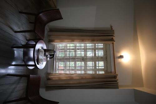 a bathroom with a window and a light on the wall at SWET APARAJITA in Bolpur