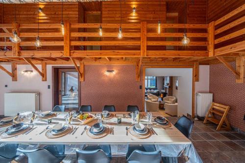 a dining room with a large table and chairs at Les Frangines in Saint-Hubert