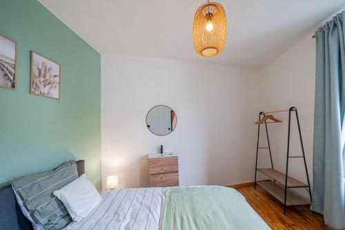 a bedroom with a bed and a mirror and a dresser at Les Frangines in Saint-Hubert