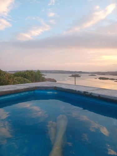 a swimming pool with a view of the ocean at Cascade Lodge & Hot Tub in Donegal