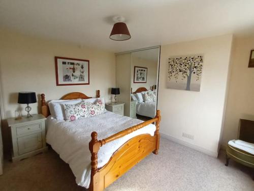 a bedroom with a bed and a large mirror at Bean's Retreat in Lees