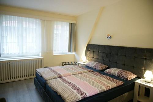 a bedroom with a large bed with two pillows at Das Sofa Restaurant-Hotel-Spätkauf in Greifswald