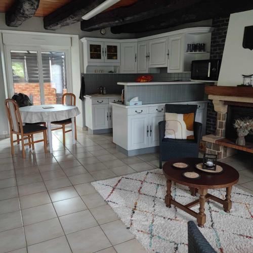 un salon avec une table et une cuisine dans l'établissement location en Bretagne, à Néant-sur-Yvel