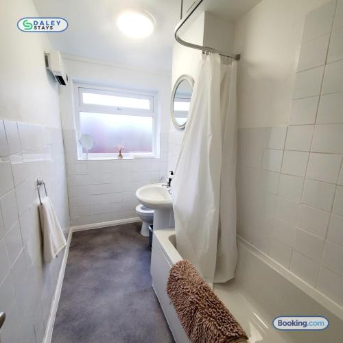 a white bathroom with a sink and a shower at Cheadle Rooftop Apartment by Daley Stays - Sleep 6 in Cheadle Hulme