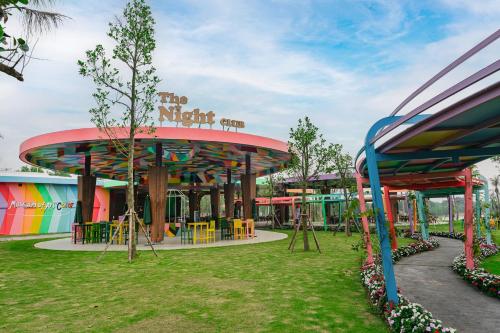 a playground in a park with a colorful building at Rosee Villa - Green Villa with private Pool in Vĩnh Phúc