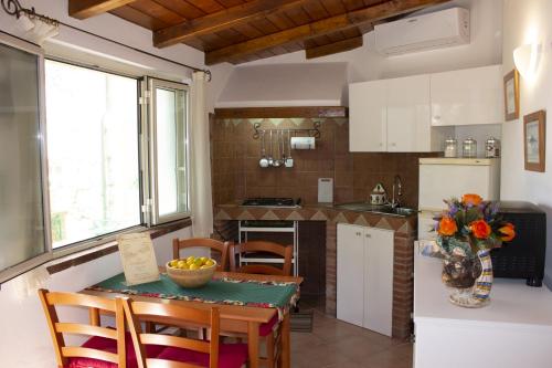 uma cozinha e sala de jantar com mesa e cadeiras em Casa Marlù em Taormina