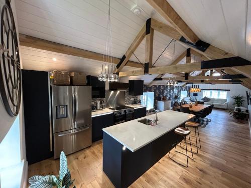 a kitchen and living room with a refrigerator and a table at Colemans Retreat in Porchfield