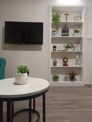 a living room with a table and a tv at Apartment GORA in Međugorje