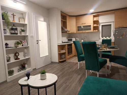 a kitchen and living room with a table and chairs at Apartment GORA in Međugorje