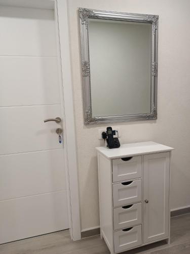 a bathroom with a mirror and a sink and a shower at Apartment GORA in Međugorje