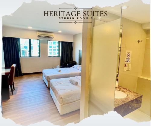a hotel room with two beds and a sign that reads heritage suites studio room at Studio Exclusive Swimming pool view by HERITAGE SUITES Near IMAGO Mall City Central , FREE HIGHSPEED WIFI & NETFLIX , KOTA KINABALU in Kota Kinabalu