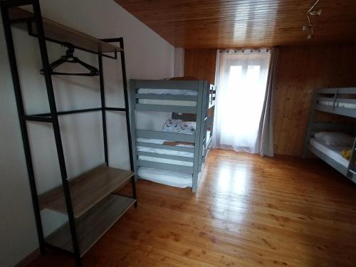 a room with two bunk beds and a window at Le Val Danse - Maison de caractère de 1870 - Rénovée en 2020 in Saint-Anthème