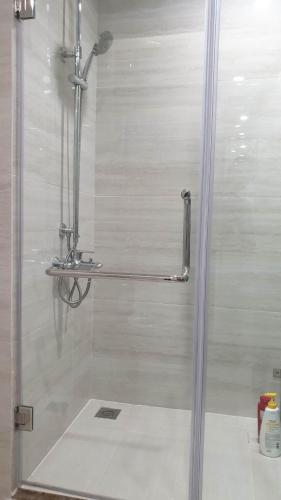 a shower with a glass door in a bathroom at Home Sweet Home in Hai Phong