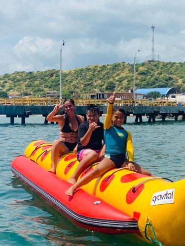 a group of people sitting on a raft in the water at La Cabaña de Iza in Canoas