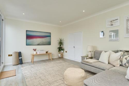 a living room with a couch and a table at West Cowes Penthouse in Cowes