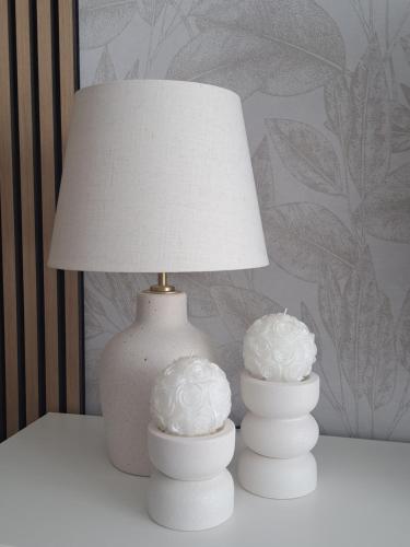two white vases sitting on a table with a lamp at Salona Lux in Klis
