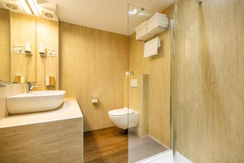 a bathroom with a toilet and a sink and a shower at Azur Palace Luxury Rooms in Split