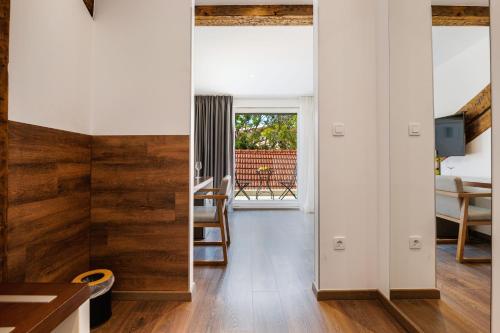 a room with white walls and wood paneling at Azur Palace Luxury Rooms in Split