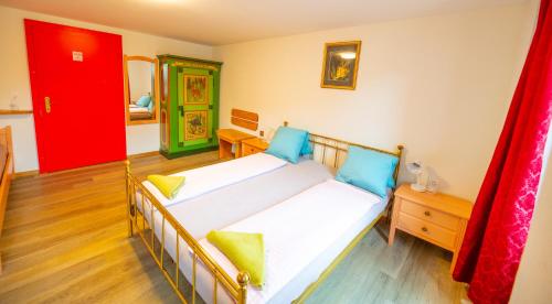 a bedroom with a bed and a red door at Residence Jungfrau in Interlaken