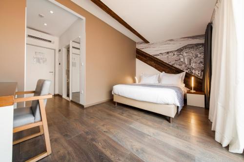 a bedroom with a bed and a painting on the wall at Azur Palace Luxury Rooms in Split
