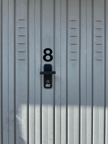 a metal wall with the number eight on it at New stone house lake view - 2 in Lezzeno