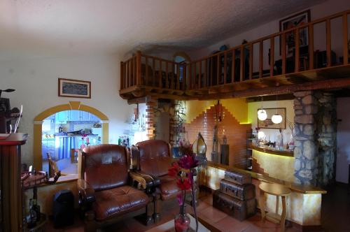 a living room with two chairs and a barber shop at Quinta Forum in Tocha