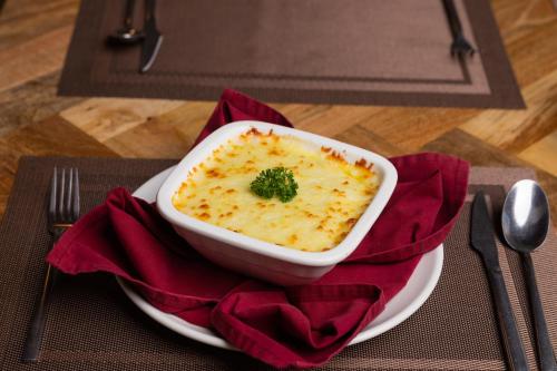 a bowl of food on a plate on a table at Aawas Boutique Hotel in Kathmandu