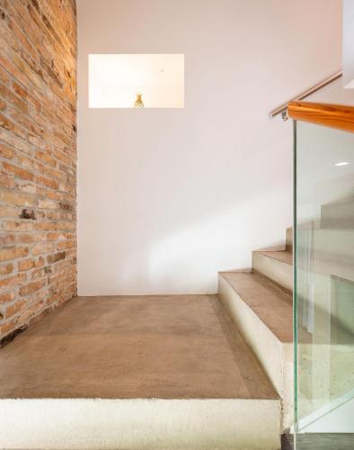 a room with stairs and a brick wall at Azur Palace Luxury Rooms in Split