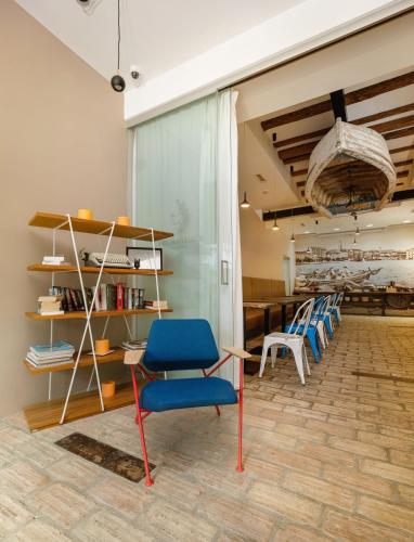 a room with chairs and a table and shelves at Azur Palace Luxury Rooms in Split