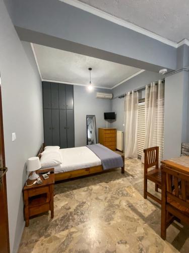 a bedroom with a large bed and a table at Akrata Studio in Akrata