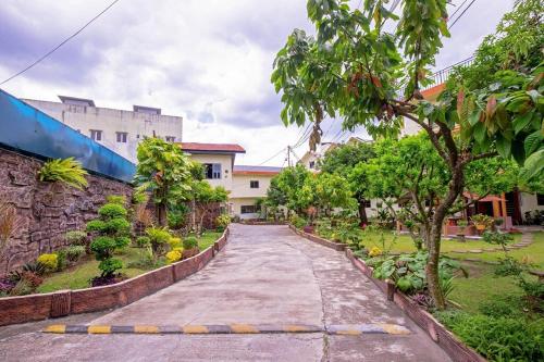 a street in a park with trees and buildings at Malibou Hotel Medan in Tebingtinggi