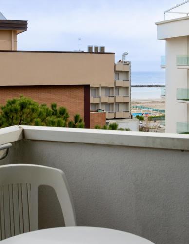 a white chair sitting on top of a balcony at Hotel Raffaello in Bellaria-Igea Marina